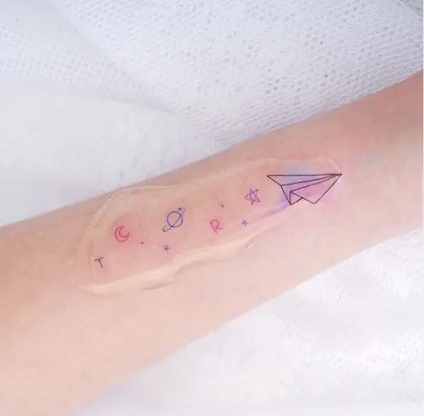 Paper Plane Lettering Tattoo with Moon, Saturn and Star