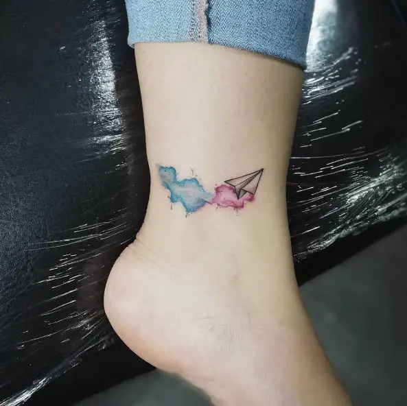 Paper Plane and Pink and Blue Water Colored Smoke Ankle Tattoo