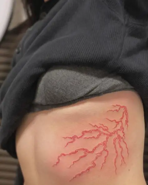 Red Lightning Streak Rib Tattoo