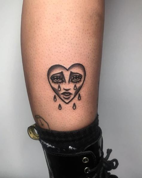 Small Greyscale Crying Heart Leg Tattoo