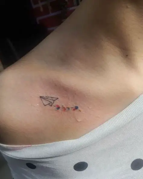 Small Paper Plane and Color Spots Collarbone Tattoo