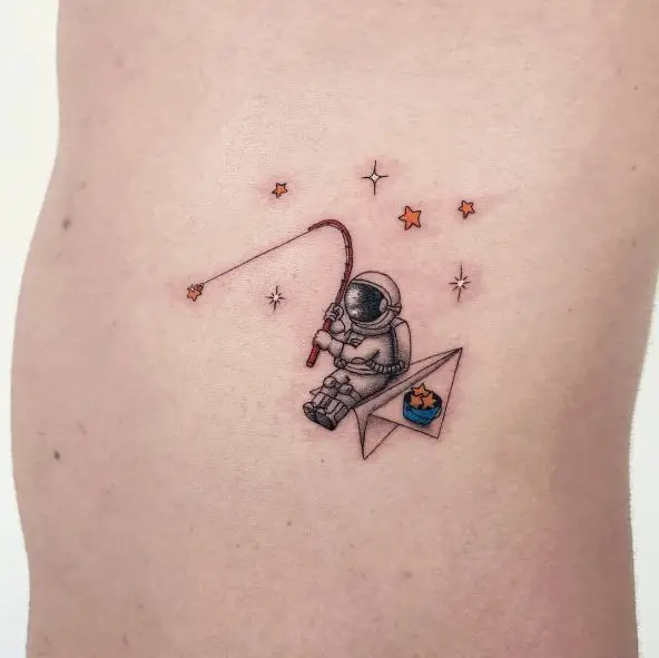 Tattoo of a Astronaut on a Paper Plane Hunting Stars