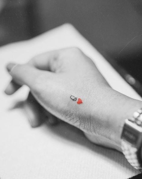 Tiny Black and Red Queen of Hearts Hand Tattoo