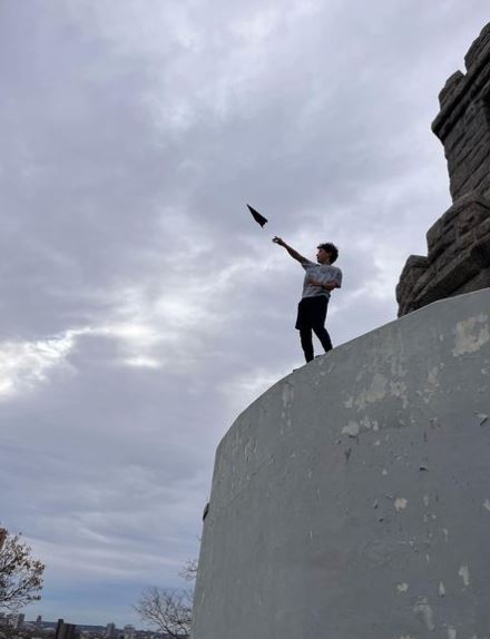 Young Boy Launching Paper Airplane at Prospect Hill Tower