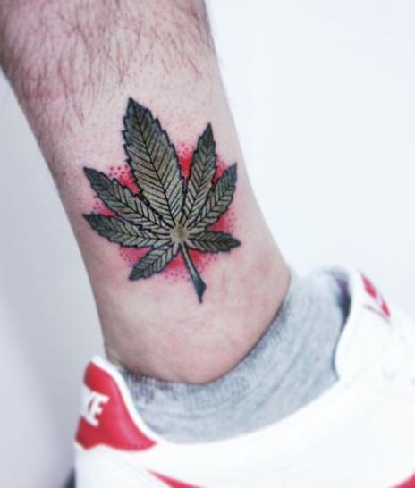 Red Background Green Marijuana Leaf Ankle Tattoo