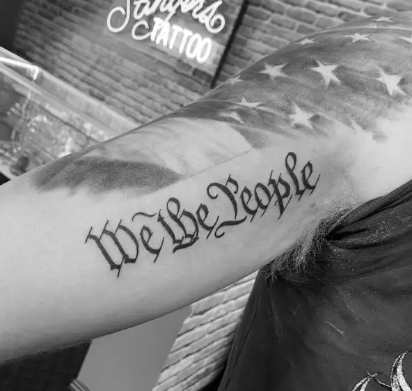 Stars and We the People Biceps Tattoo