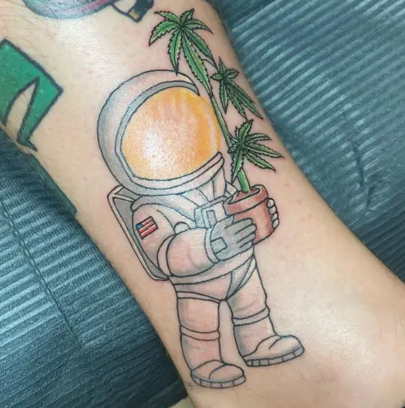 Colored Astronaut and Weed Plant Tattoo