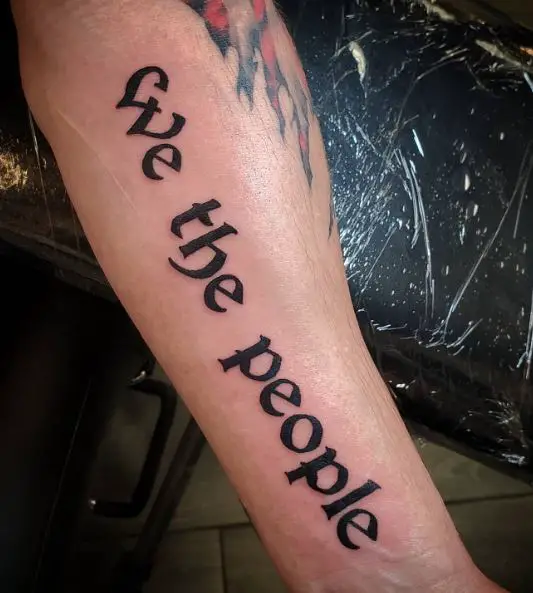 Black Bold We the People Forearm Tattoo