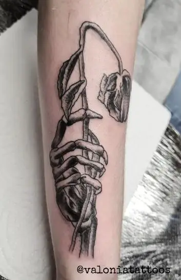Skeleton Hand holding Dying Rose Arm Tattoo