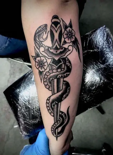 Black and Grey Snake and Dagger with Flowers Forearm Tattoo