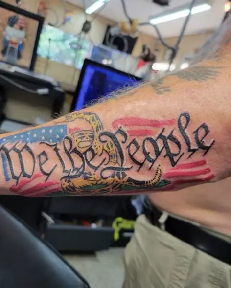 Snake and We the People Forearm Tattoo