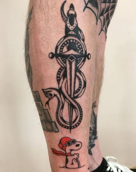 Black and Grey Snake and Dagger with Snoopy Calf Tattoo