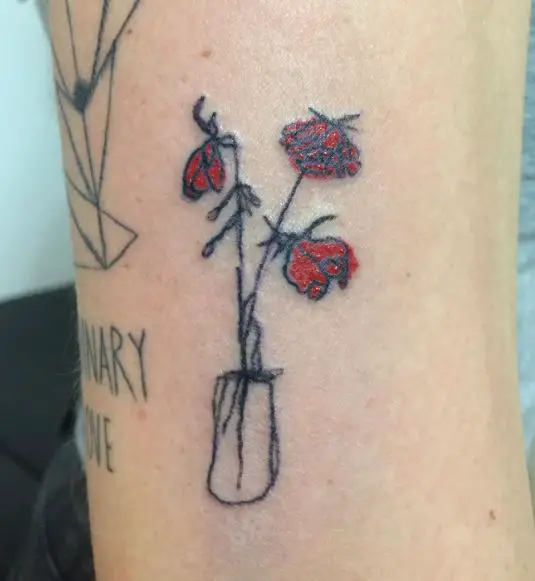 Dying Red Roses in Vase Arm Tattoo
