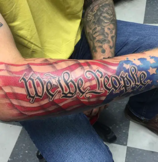 We the People over American Flag Forearm Tattoo