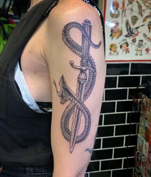 Grey Shaded Snake and Dagger Arm Tattoo