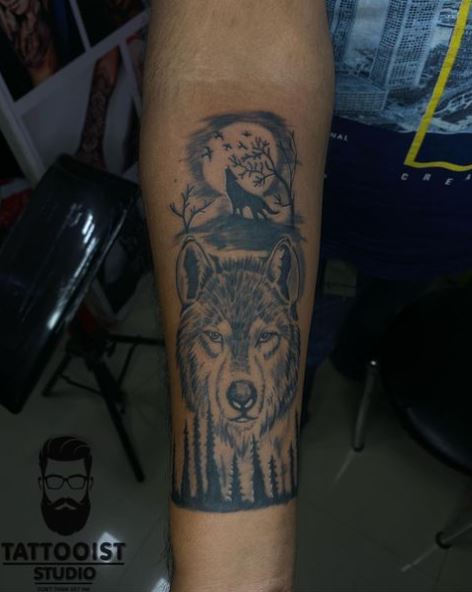 Forest with Wolf Head and Howling Wolf Arm Tattoo