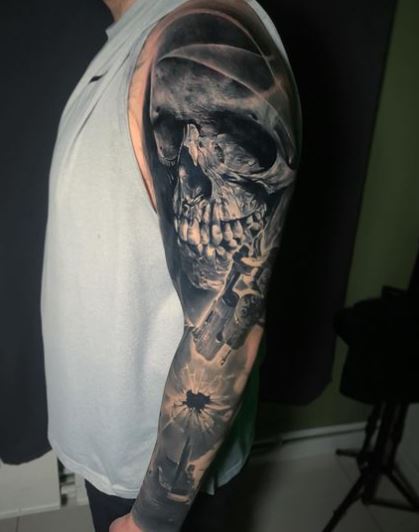 Black and Grey Revolver and Skull Arm Sleeve Tattoo