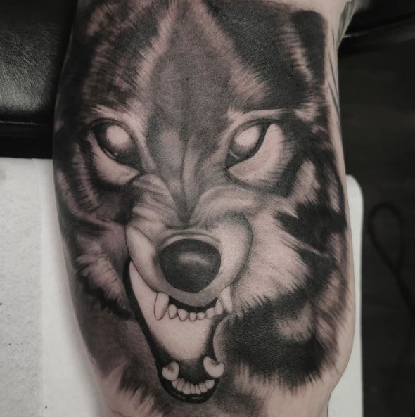 Black and Grey Snarling Wolf with Glowing Eyes Tattoo