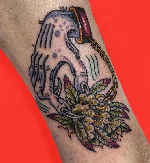 Hand in Chain and Weed Bud Arm Tattoo
