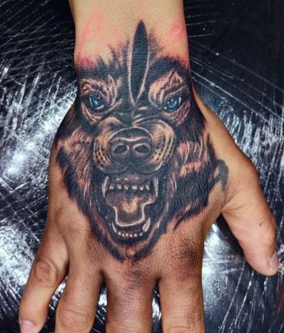 Dark Angry Wolf with Blue Eyes Hand Tattoo