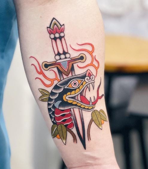 Traditional Dagger Stabbed in Snake Head Forearm Tattoo