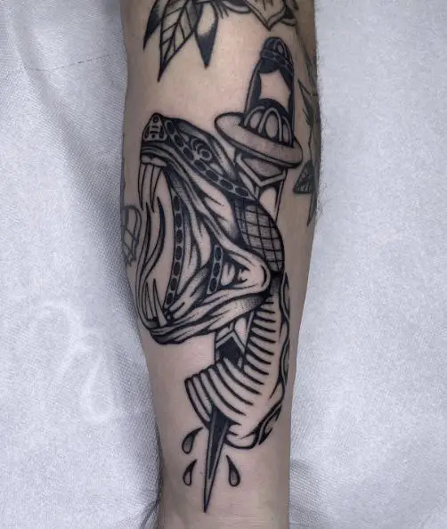 Black and Grey Dagger Stabbed in Snake Head Forearm Tattoo