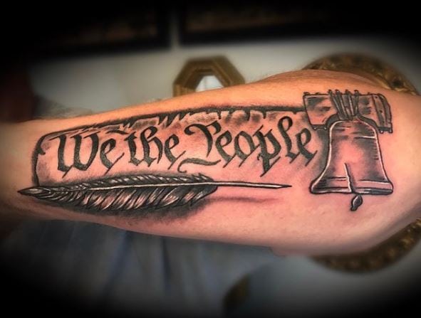 We The People with Liberty Bell and Feather Arm Tattoo