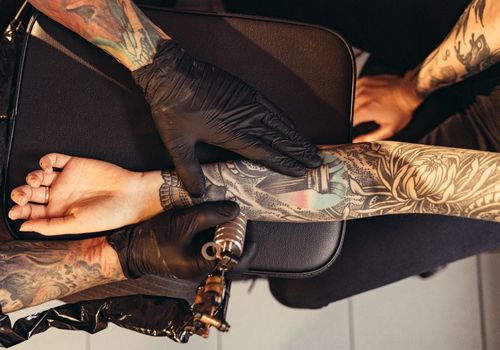Artist Injecting a Forearm Tattoo