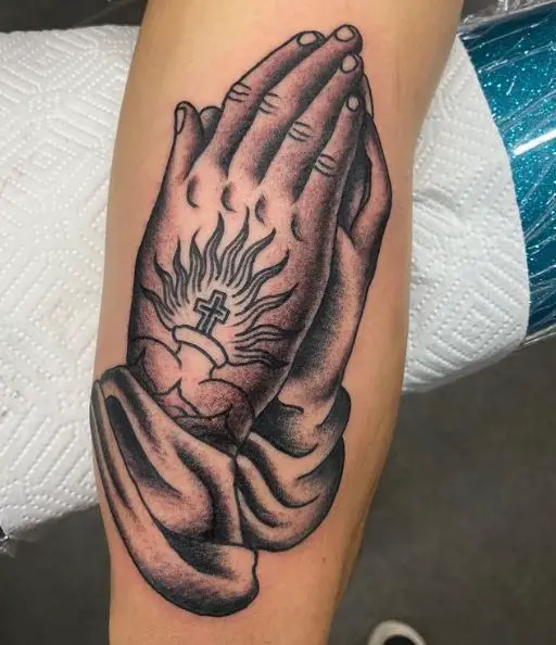 Black and Grey Praying Hands with a Tiny Cross Tattoo
