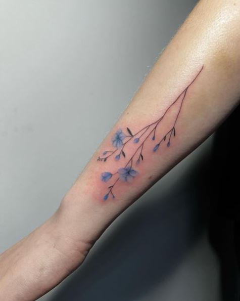 Blue Flowers and Black Stem Forearm Tattoo