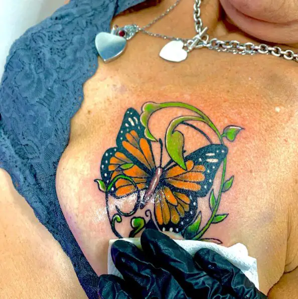 Butterfly and Plant Breast Tattoo