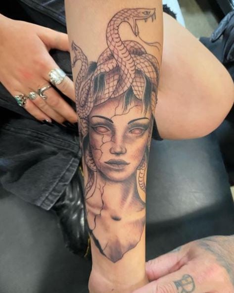 Greyish Medusa Symbol Tattoo