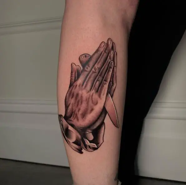 Praying Hands with a Knife Arm Tattoo