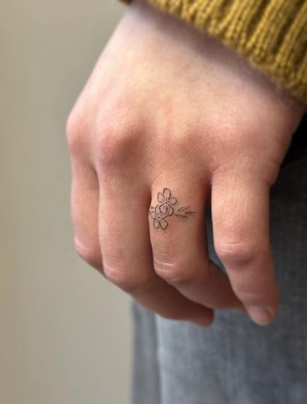 Tiny Black Flowers Ring Tattoo