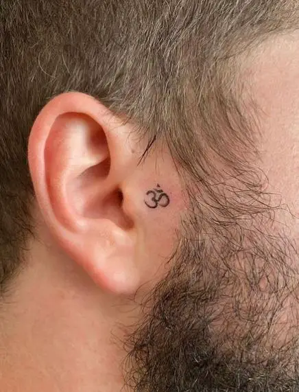 Tiny Om Symbol Face Tattoo