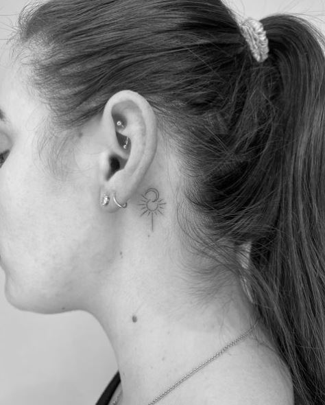 Tiny Sun and Moon Tattoo Behind the Ear