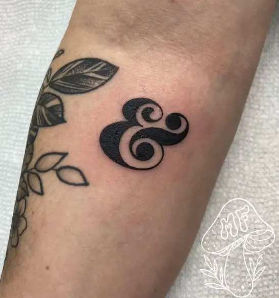 Black Bold Ampersand Forearm Tattoo