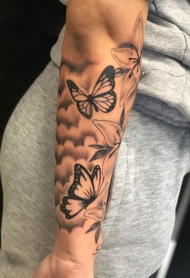 Shaded Clouds and Butterflies Forearm Tattoo
