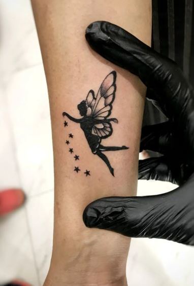 Black Stars and Shadow Fairy Forearm Tattoo