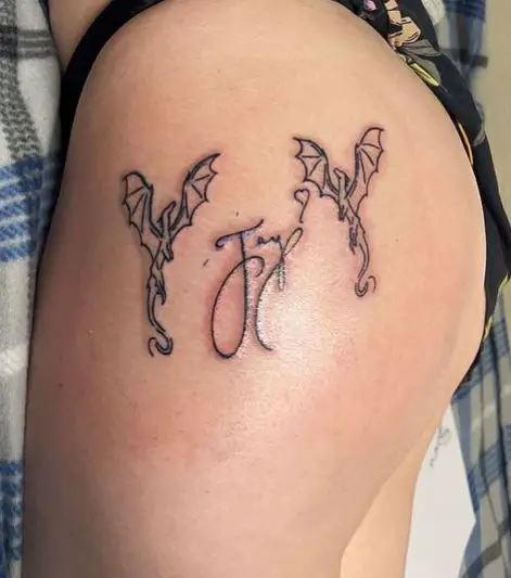 Name and Two Flying Dragons Butt Tattoo