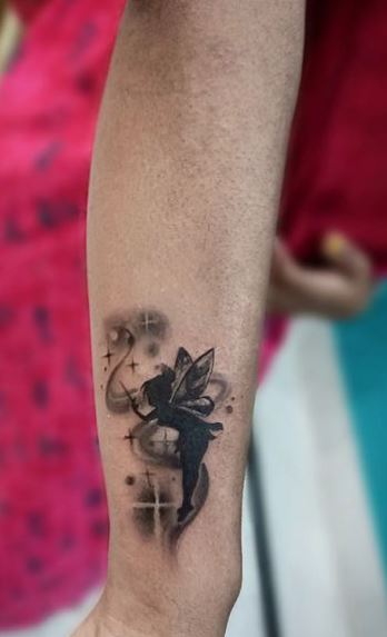 Black and Grey Shadow Fairy with Fairy Dust Forearm Tattoo