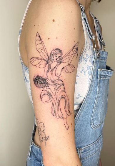 Grey Fairy with Basket of Flowers Arm Tattoo