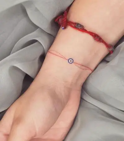 Red Bracelet and Evil Eye Wrist Tattoo