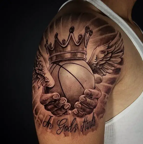 Lettering and Hands Holding Basketball with Wings Shoulder Tattoo