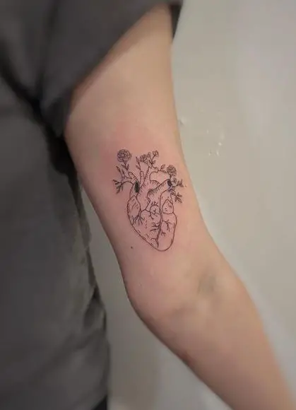 Flowers and Human Heart Biceps Tattoo
