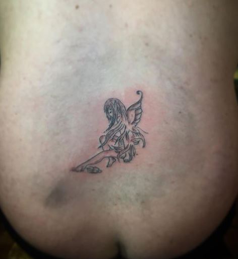 Grey Shaded Sitting Fairy Belly Tattoo