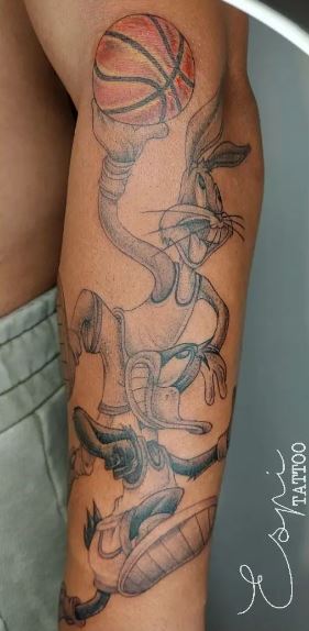Bugs Bunny and Duffy Duck Playing Basketball Arm Tattoo