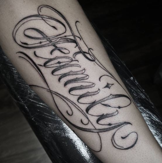 Grey Letters Family Chicano Forearm Tattoo