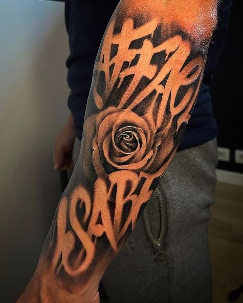 Black and Grey Lettering and Rose Chicano Forearm Tattoo
