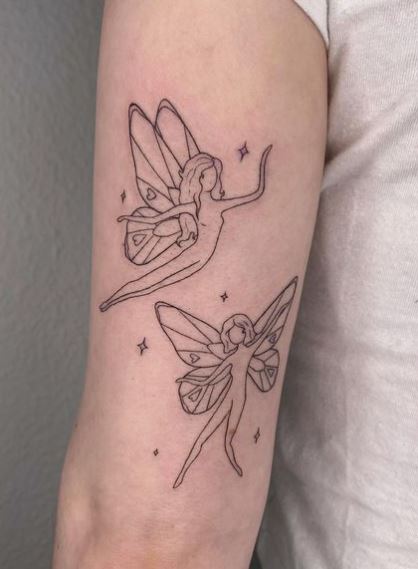 Black and Grey Stars and Two Fairies Arm Tattoo